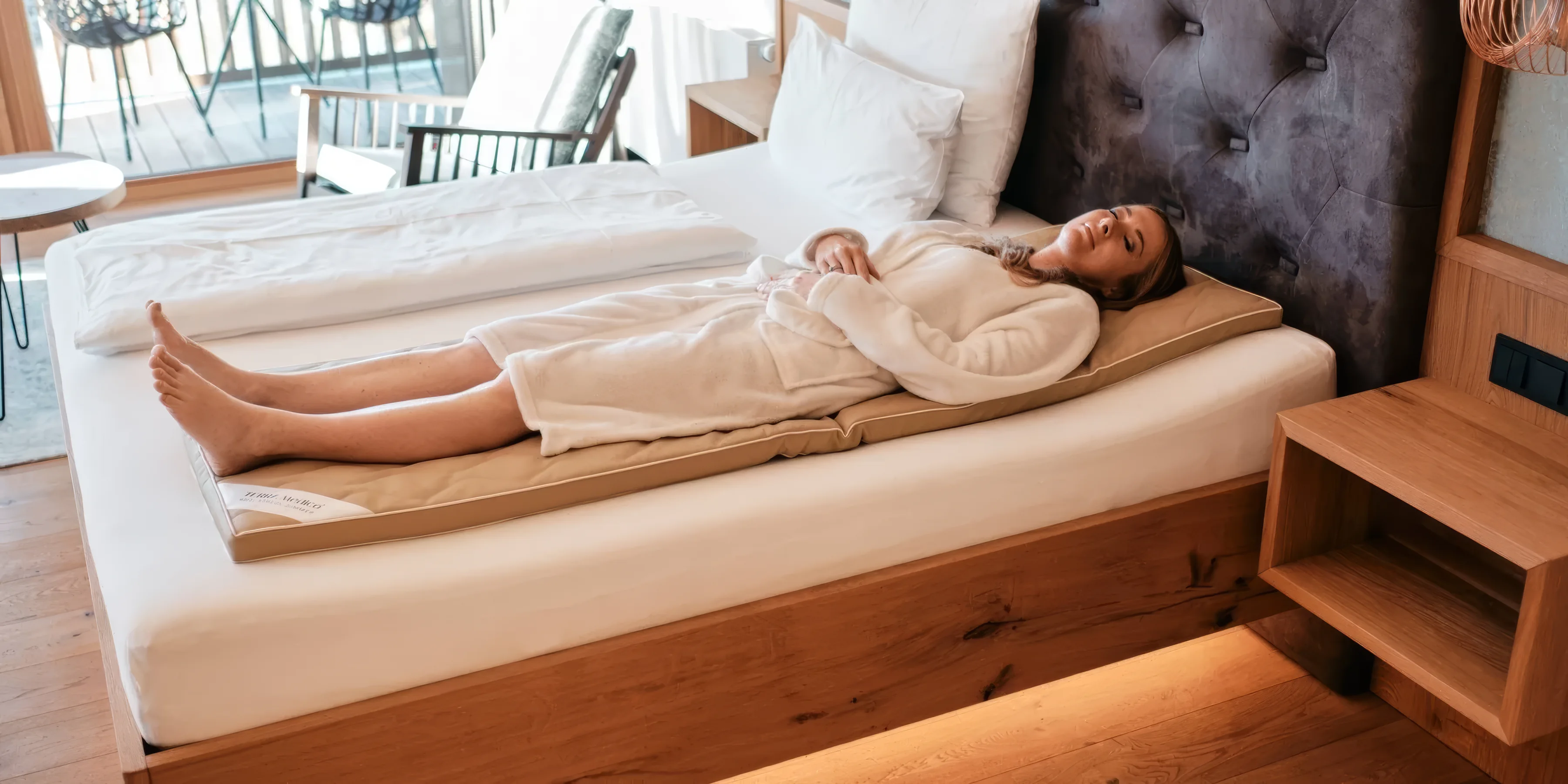 Woman lying relaxed on the BETTER³ Regeneration System